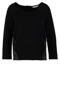 Pull noir en maille à manches longues avec encolure ronde et détails en panneaux en mesh sur les côtés.