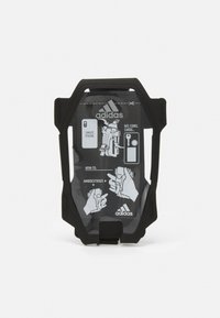 Supporto per telefono mobile nero con una parte frontale trasparente che mostra le istruzioni. Caratterizzato da un design resistente e funzionalità ambidestra per vari oggetti.