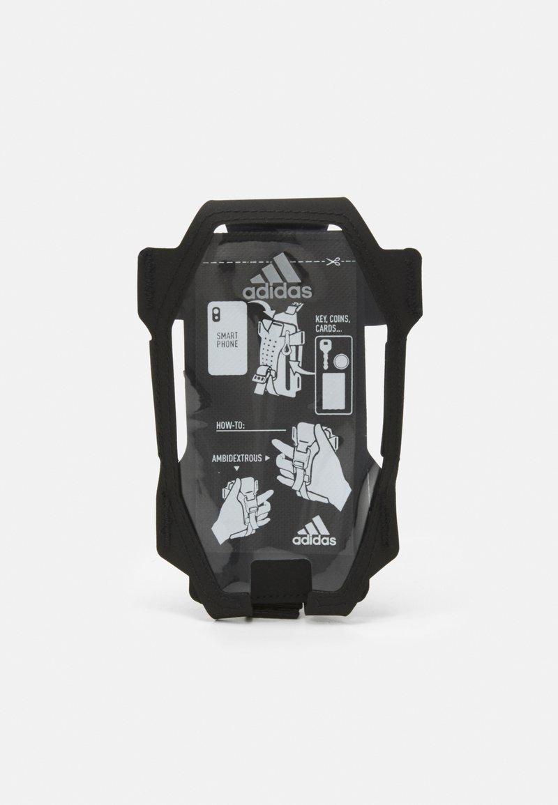 Supporto per telefono mobile nero con una parte frontale trasparente che mostra le istruzioni. Caratterizzato da un design resistente e funzionalità ambidestra per vari oggetti.