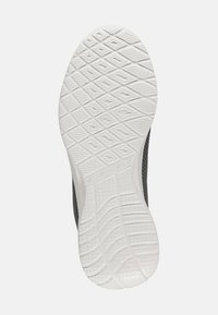 Suela de zapatilla Skechers con un fondo de goma blanca con patrón, diseño de agarre texturizado, tacón redondeado y arco ligeramente elevado.