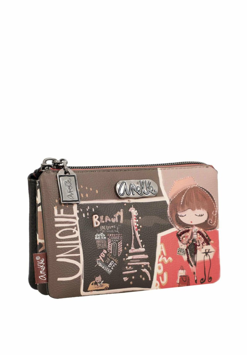 Cartera de cuero marrón que presenta arte de la Torre Eiffel y figuras estilizadas. Tiene cremallera con un logotipo de acento plateado y un charm decorativo.