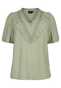 Blusa verde chiaro a maniche corte con scollatura a V, bordo arricciato e tessuto a rilievo con piccole macchioline sollevate. Progettata con delicati dettagli in pizzo.