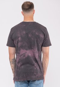 Short-sleeve, gray T-shirt with a dark maroon tie-dye pattern. Features a crew neckline and a relaxed fit. Textured cotton fabric.