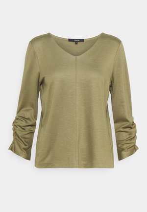 Light olive green long-sleeve blouse with ruched sleeves and a subtle center seam, featuring a round neckline.