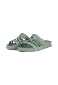 Green slide sandals with a textured rubber sole, featuring crossed straps and a braided detail on the top, designed for comfort.