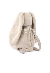 Mochila de peluche en forma de conejo beige con orejas largas, correas de tela ajustables y un zipper en la parte trasera, mostrada sobre un fondo blanco.