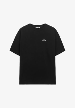 Black short-sleeve T-shirt with small white "UNFAIR" text on the left chest, crew neck, and a slightly textured fabric.