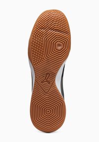 Suela de zapato de goma marrón texturizada, con patrones hexagonales y un logotipo. Detalles en blanco y negro en los laterales. Elementos de diseño en forma circular.