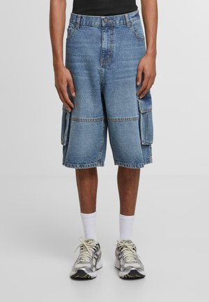 Denim cargo shorts in light blue, featuring a loose fit, knee length, two large side pockets, and visible stitching details.