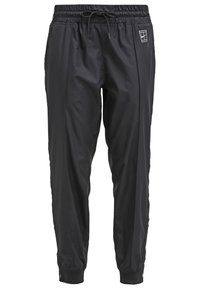 Black athletic pants made of lightweight material, featuring an elastic waistband, drawstring, side pockets, and snap accents at the ankles.