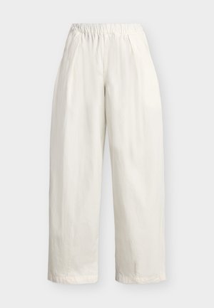 Wide-leg white pants with elastic waistband and side pockets, made from lightweight fabric, displayed against a plain background.