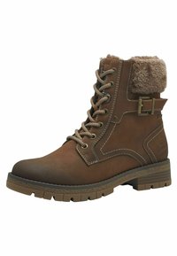 Botte cheville en cuir marron avec un collier en fausse fourrure, design à lacets, œillets en métal et semelle en caoutchouc texturée et épaisse. Accentuée par des détails de couture.