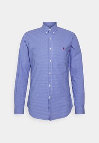 Niebieska i biała koszula w kratę zapinana na guziki, z długimi rękawami, klasycznym kołnierzykiem, z małym czerwonym logo na piersi. Wykonana z bawełny, o gładkiej fakturze.