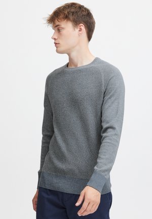 Gray knit sweater with textured pattern, ribbed neckline, and cuffs. Features a straight cut and a slightly tapered hem.
