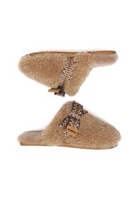 Fuzzy, tan slip-on slippers with a fluffy wool exterior. Features a patterned fabric strap and a sturdy tan sole with brand label.