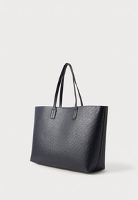 Czarna torba tote o fakturze z dwiema uchwytami, zdobiona geometrycznym wzorem i o sztywnej konstrukcji, wykonana z materiału syntetycznego.