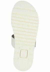 White rubber shoe sole with textured grip pattern, featuring horizontal ridges and a logo labeled "High Soft" near the heel area.