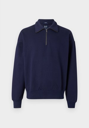 Navyblaues Sweatshirt mit Reißverschluss aus Baumwollmischung. Es verfügt über einen Kragen, lange Ärmel, gerippte Bündchen und einen lockeren Schnitt. Glatte, einfarbige Textur.