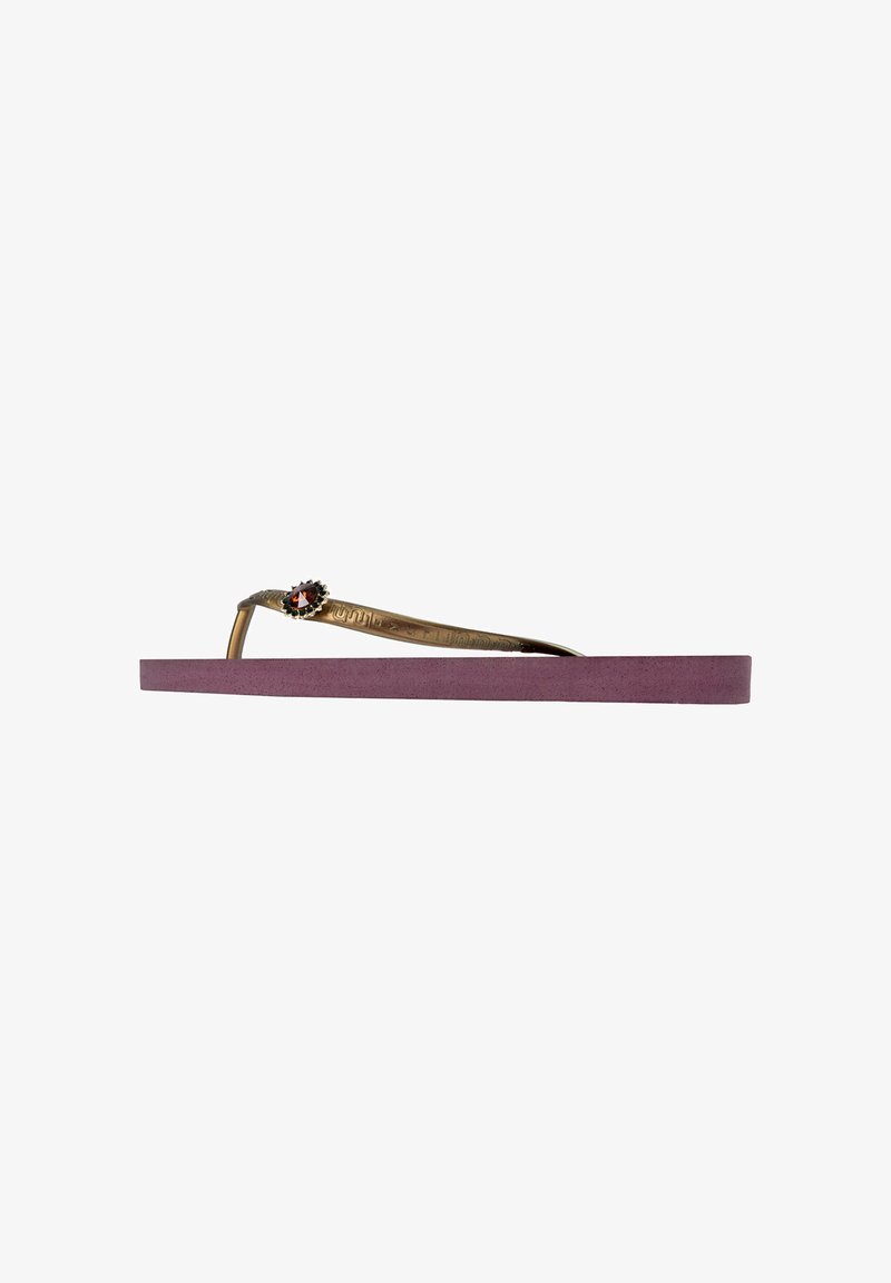 Flip-flop with lavender rubber sole, metallic gold strap featuring a floral accent with a red gemstone at the intersection. Flat design.