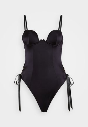 Costume intero nero con busto strutturato e imbottito, spalline sottili, fiocchi laterali e tessuto liscio per un design aderente.