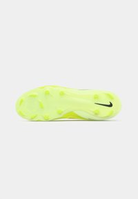 Nike fodboldstøvlesålen i livlig gul med cirkulære stød for traction. Har et slankt design og en glat tekstur.