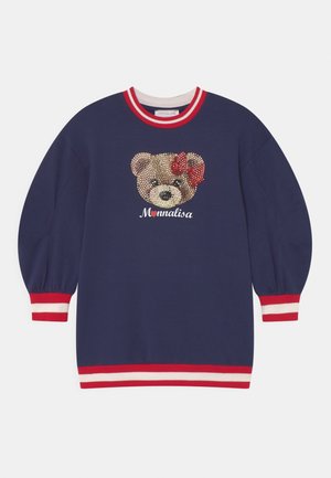 Vestido sudadera azul marino con diseño de oso adornado con piedras de strass y un lazo rojo. Puños y cuello acanalados con rayas rojas y blancas. Tejido suave.