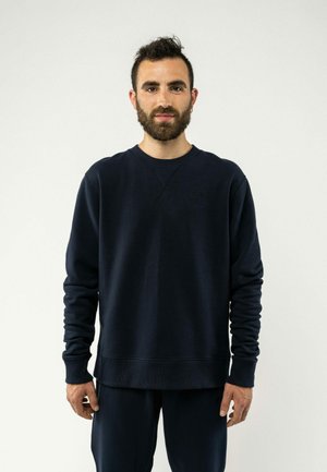 Dunkelblaues Sweatshirt aus weichem Material mit langen Ärmeln, gerippten Bündchen und einem Rundhalsausschnitt. Verfügt über ein dezentes Logo auf der Brust.