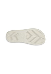 Witte rubberen schoenenzool met een gestructureerd grippatroon en verhoogde lijnen, met een cirkelvormig logo in het midden en soepele randen.