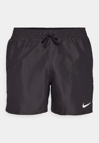 Shorts de bain noirs en tissu léger. Taille élastique avec cordon de serrage. Présente un logo blanc de Nike en bas à droite.