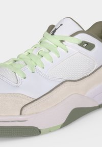 Λευκό και ανοιχτοπράσινο αθλητικό παπούτσι με υφασμένες πλαϊνές επιφάνειες, κλείσιμο με κορδόνια, μαλακό περιμετρικό μέρος και λαστιχένια σόλα με μοτίβο κράτησης.
