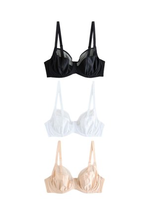 Femme aux cheveux blonds mi-longs portant un soutien-gorge couleur chair, posant avec un bras levé et regardant légèrement vers le haut.