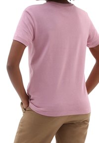 Růžové bavlněné tričko s krátkými rukávy a kulatým výstřihem, s hladkou texturou a volným střihem. Hodí se k béžovým kalhotám.