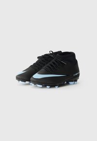 Black soccer cleats with a high-top design, featuring a light blue swoosh, black laces, and a textured surface with six blue studs.