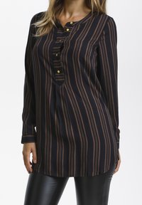 Blouse à manches longues en tissu léger présentant des rayures verticales bleu marine et marron, détails de boutons au niveau de l'encolure, et une coupe décontractée.