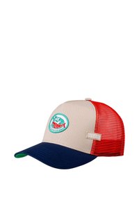 Beige trucker cap with red mesh sides and a navy brim. Features a circular embroidered patch depicting a wave and palm trees. Brand label visible.