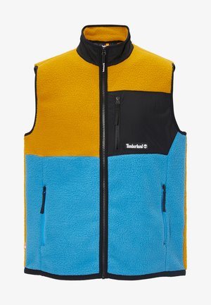 Fliisvest, millel on kollased ja sinised paneelid, mustad aktsendid, kõrge krae, ees lukuga ja kaks külge lukuga taskut, tekstureeritud soojus.