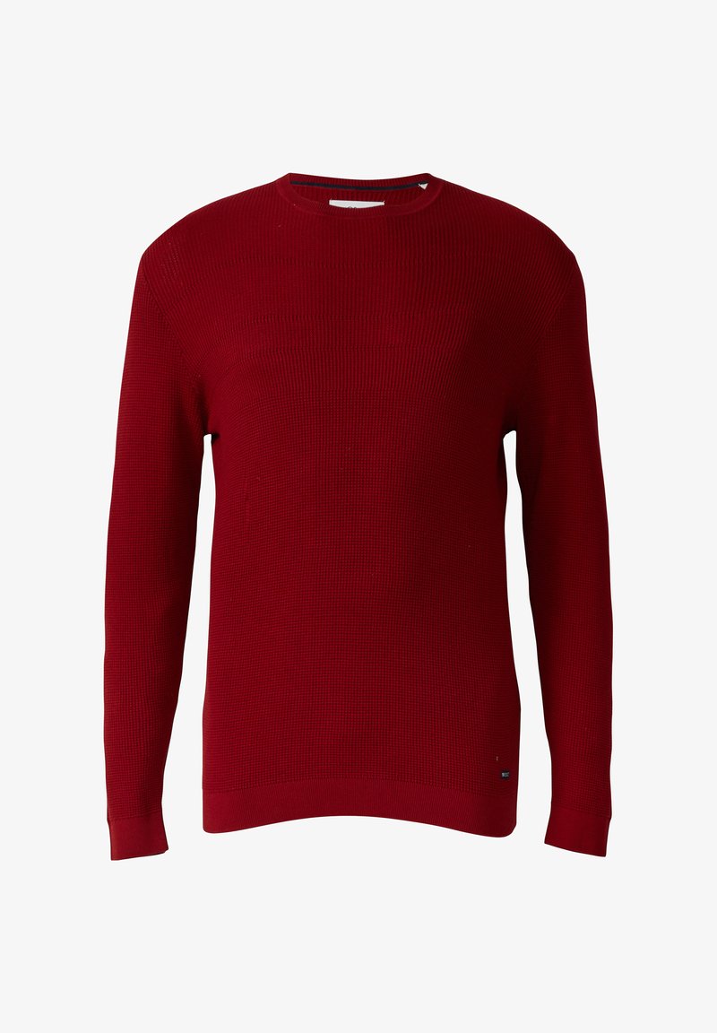 Red knitted sweater with long sleeves, round neckline, ribbed texture, and a straight hem. Small logo detail at the hem.