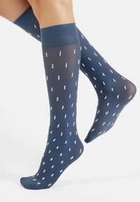 Knee-high socks in a deep blue, featuring a sheer material and scattered white brushstroke patterns; ribbed top band for secure fit.
