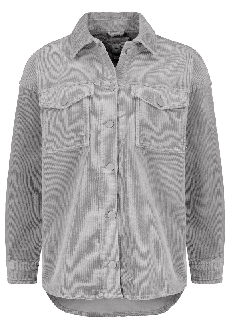Giacca camicia in corduroy grigia con chiusura a bottone, due tasche sul petto e un orlo posteriore leggermente più lungo. Presenta una texture a coste e colletto rotondo.