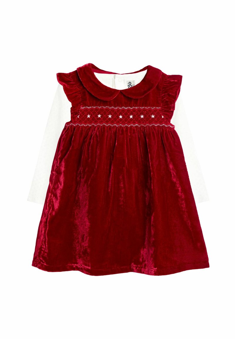 Rotes Samtkleid mit rundem Kragen, Rüschensleeves, gerafftem Oberteil mit Sternenmotiven und schwingendem Rock. Weiße Langarmbluse darunter.