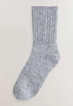 Hall hallidega sokk, millel on tekstureeritud pind, tugevdatud varras ja sujuv varvas. Materjal näeb välja pehme ja paindlik.