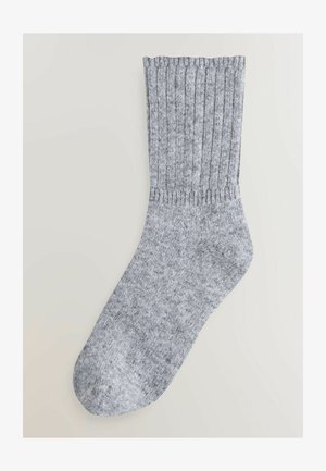 Hall hallidega sokk, millel on tekstureeritud pind, tugevdatud varras ja sujuv varvas. Materjal näeb välja pehme ja paindlik.