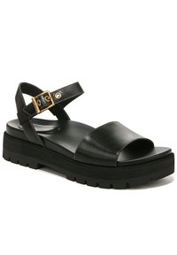 Zwarte leren sandaal met een brede band, open teen en verstelbare enkelband met gesp. Kenmerkt zich door een chunky zwarte zool met een gestructureerde loopvlak.