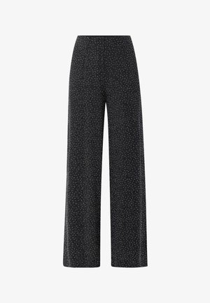 Zwarte wijde broek met wit gespikkeld patroon, voorzien van een elastische tailleband en een gladde textuur.