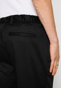 Calvin Klein Trousers - black