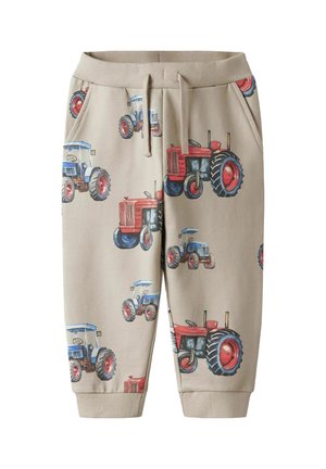 Beige Sweatpants mit einem wiederholten Traktor-Muster in Rot und Blau. Entworfen mit einem elastischen Bund und Seitentaschen.