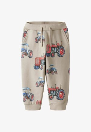 Beiga sweatpants med ett upprepat traktortryck i röd och blå. Designade med resårmidja och sidofickor.