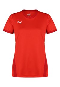 Maglietta sportiva rossa in tessuto sintetico. Presenta maniche corte, un collo rotondo e dettagli con logo bianco sul petto e sulle spalle.