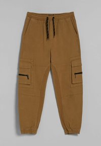 Cargo kalhoty v barvě tan, s elastickým pasem na šňůrku, bočními kapsami a kapsou na zip na stehně.