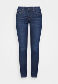 Dark blue denim skinny jeans with subtle fading, five-pocket design, and a zip-fly closure. Stitched accents around pockets and waistband.